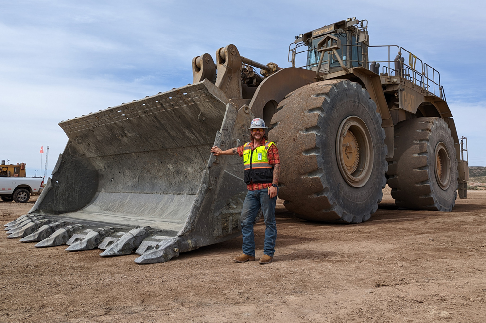 Man in front of large tractor